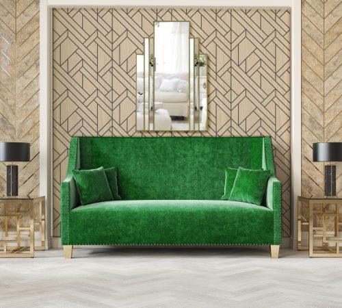 Art deco style beige interior with green sofa, columns, table lamp, moldings.